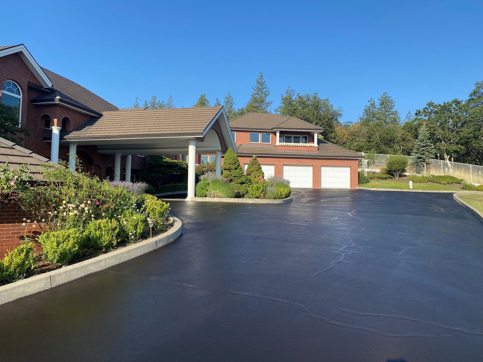 Freshly sealcoated asphalt driveway by Musser Sealcoat and Paving Inc.