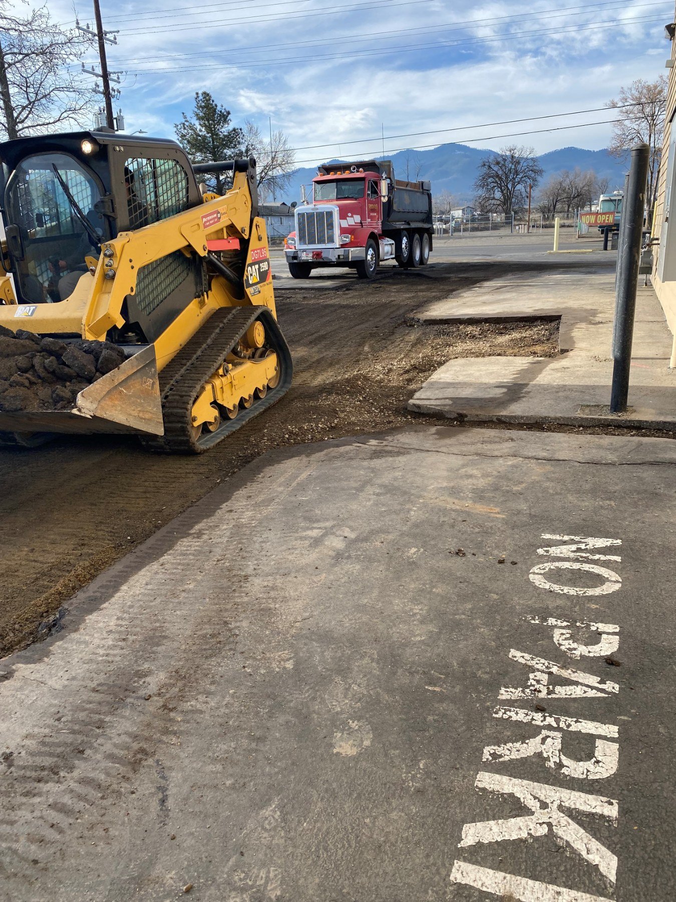 Asphalt repair preparation with skid steer equipment by Musser Sealcoat and Paving Inc.