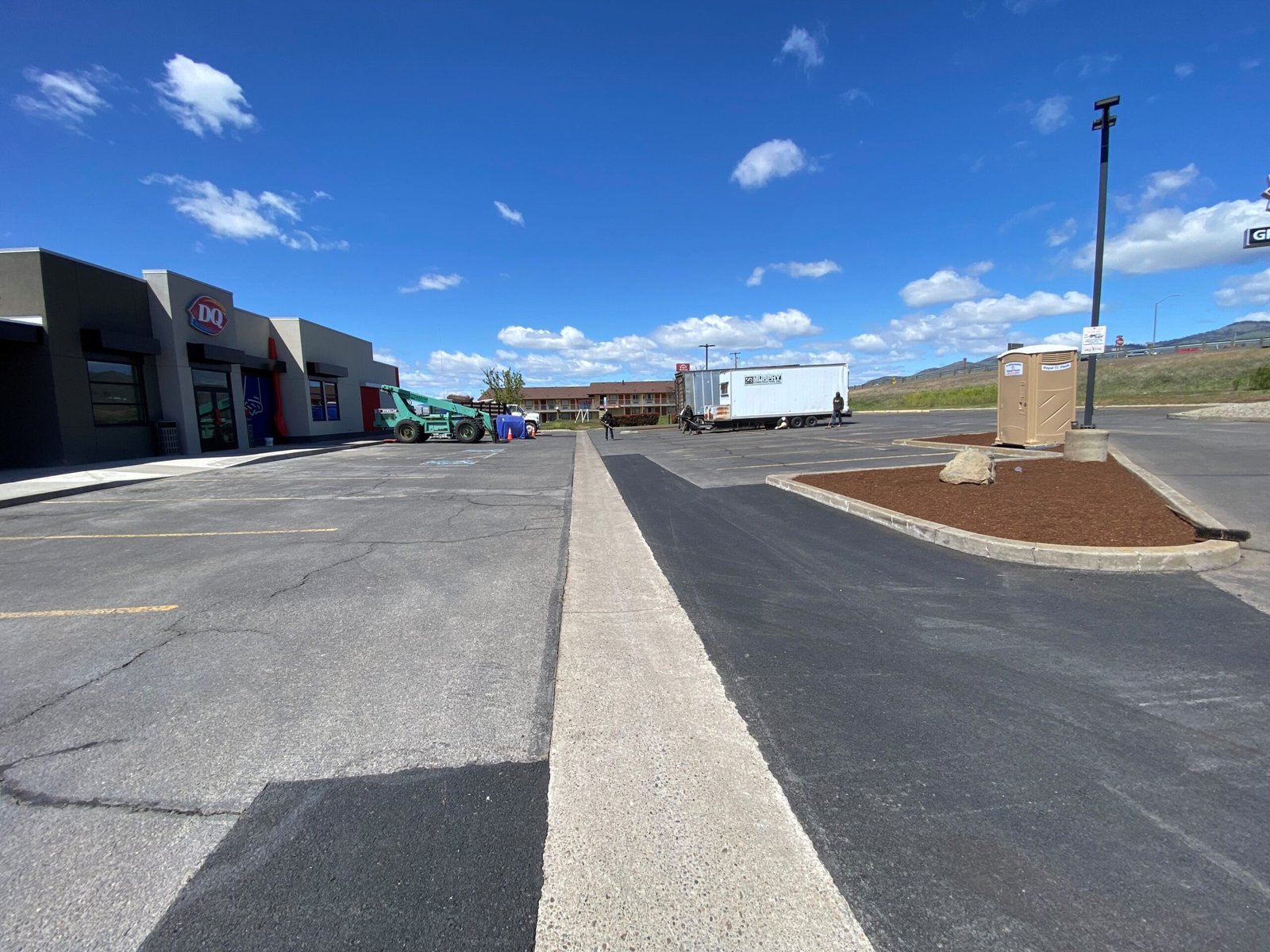 Finished dark asphalt sealcoating project by Musser Sealcoat and Paving Inc.
